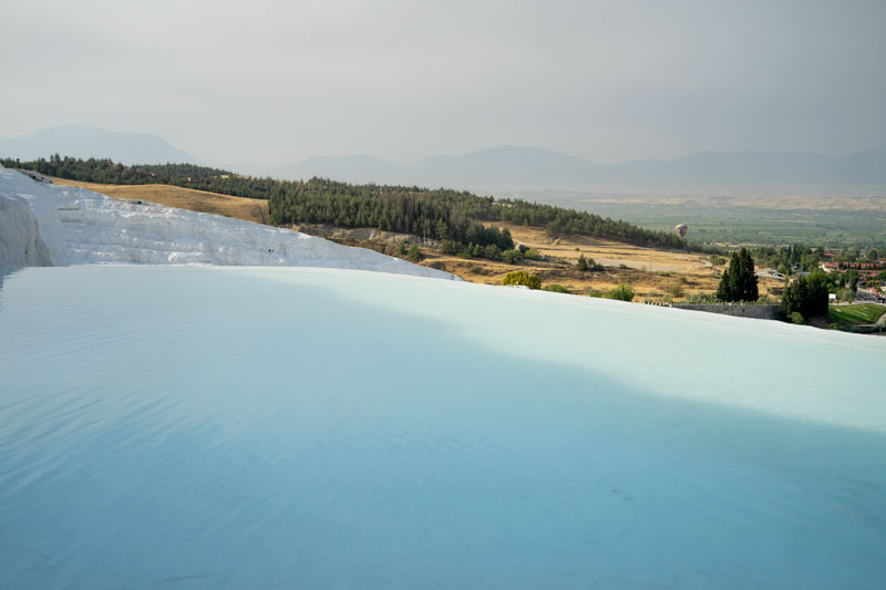 the blue water and white cliffs of the travertines in Pamukkale