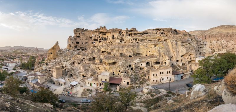 A rock village surrounded by mountains with caves