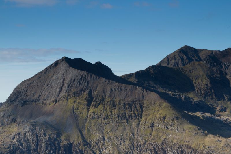 The east face and north ridge of Crib Goch with mount Snowdon in the distance, located in the Snowdonia National Park, Wales, UK