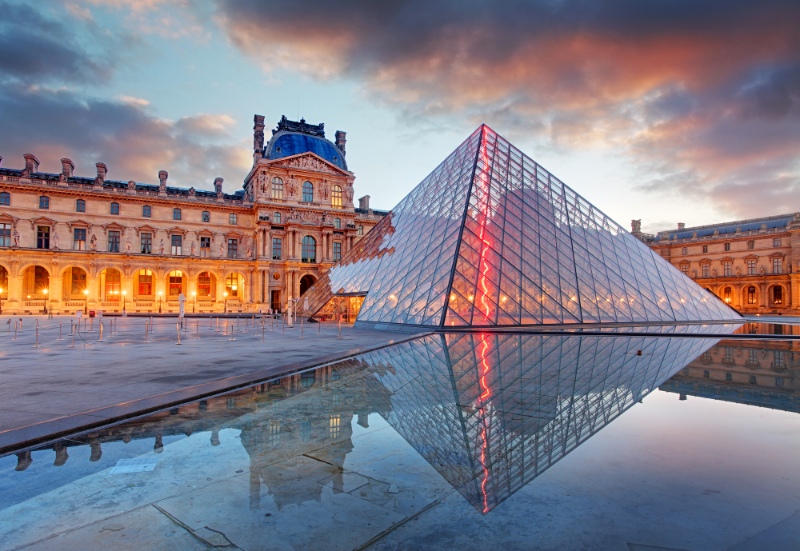 The glass pyramid in front of the magnificent building at the Louvre Paris
