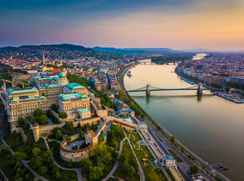Aerial skyline view of Buda Castle Royal Palace and South Rondella with Castle District and Szechenyi Chain Bridge at sunrise