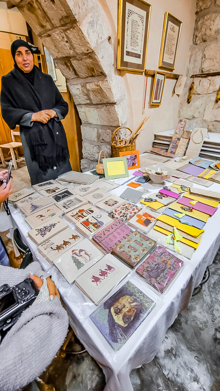 woman in muslim dress at a handcrafted paper stand