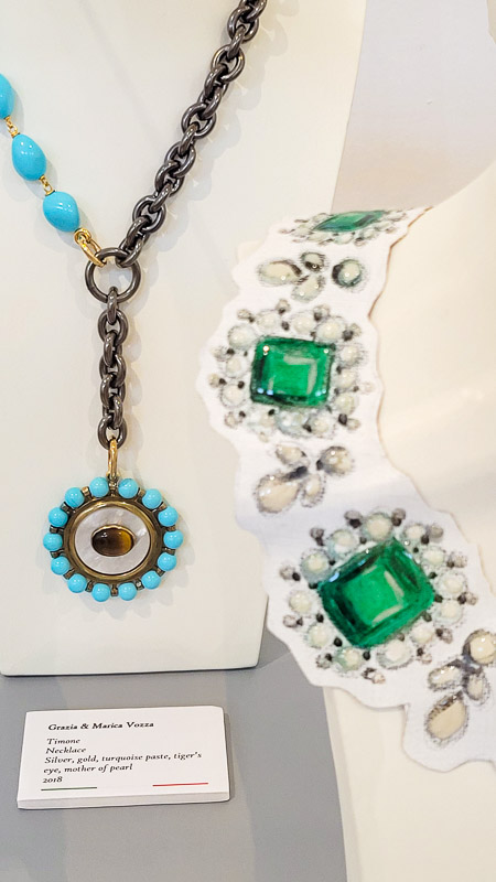 blue stoned necklace and green stoned necklace on table