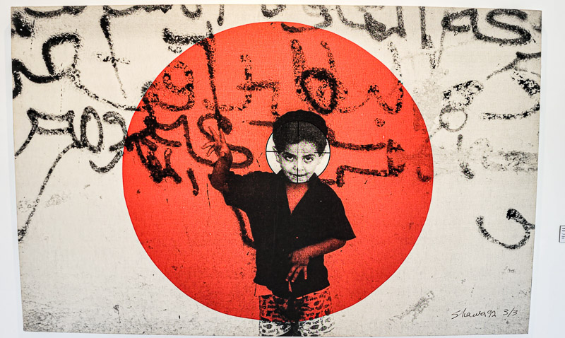 painting of young boy in a red circle with arabic writing