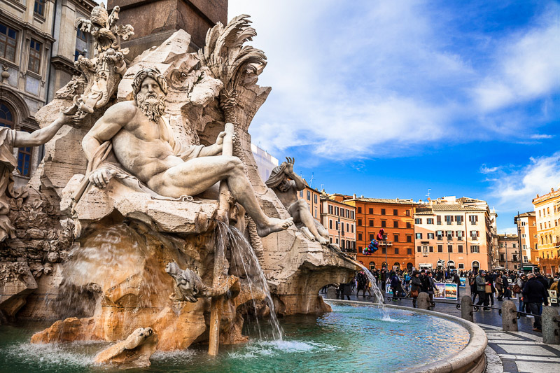 statue of naked man in the middle of water fountain in the piazza Navona