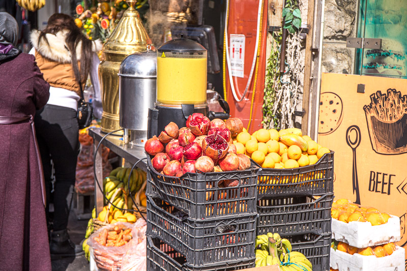 people standing at fruit stand in amman jordan