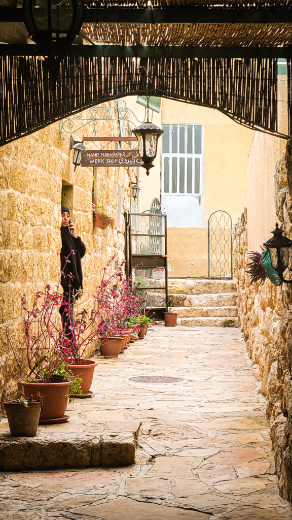 Women in muslim dress standing in a stone alleyway