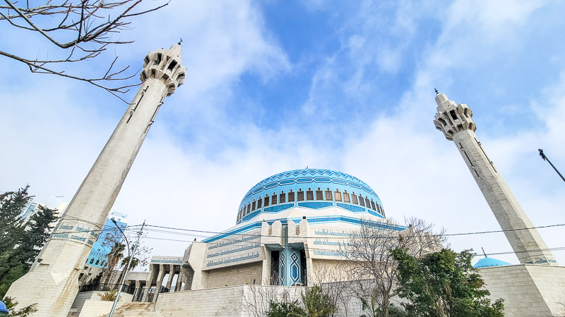white mosque with turrets and blue dome