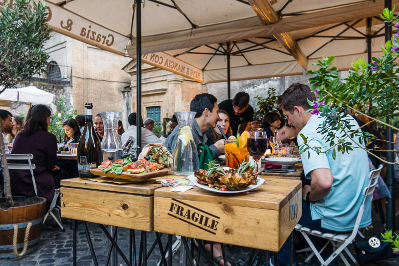people having dinner at an outdoor italian restaurant in Trastevere