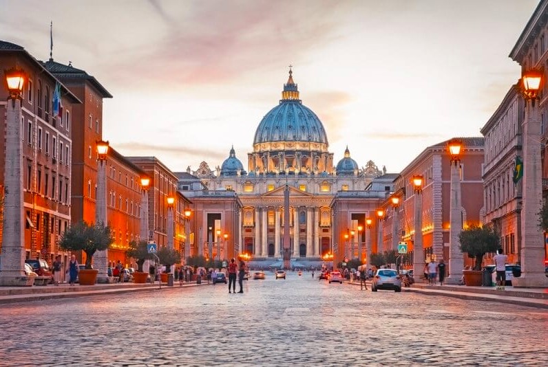View of Illuminated Saint Peter`s Basilica and Street Via della
