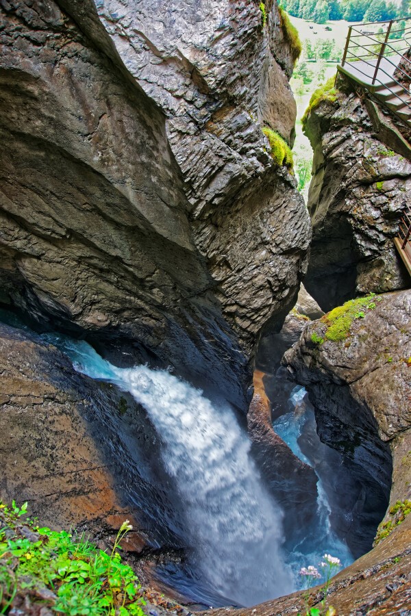 waterfall carving a slot canyon