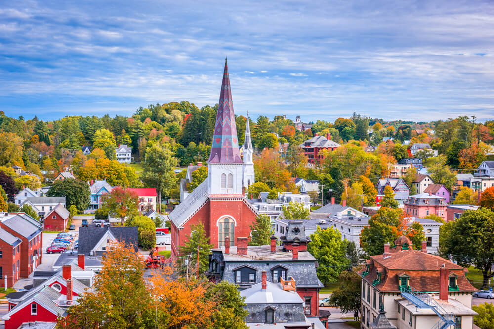 colorful church and steeple surrounded by fall foliage in montpelier