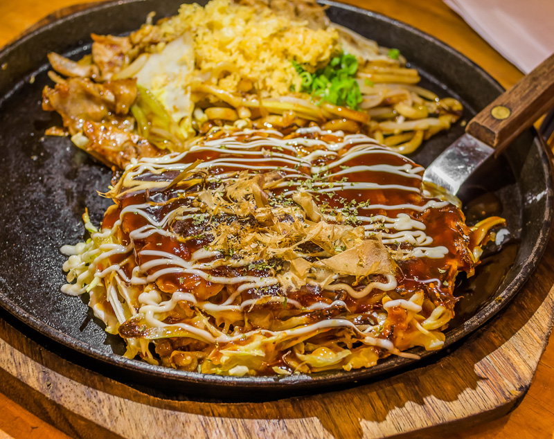 Closeup Cooking Okonomiyaki or japan pizza with hot iron frying