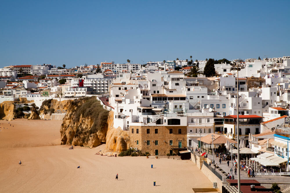 white buildings on the edges of cliff faces in Albufeira