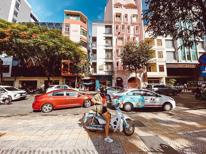 woman on scooter in city street da nang
