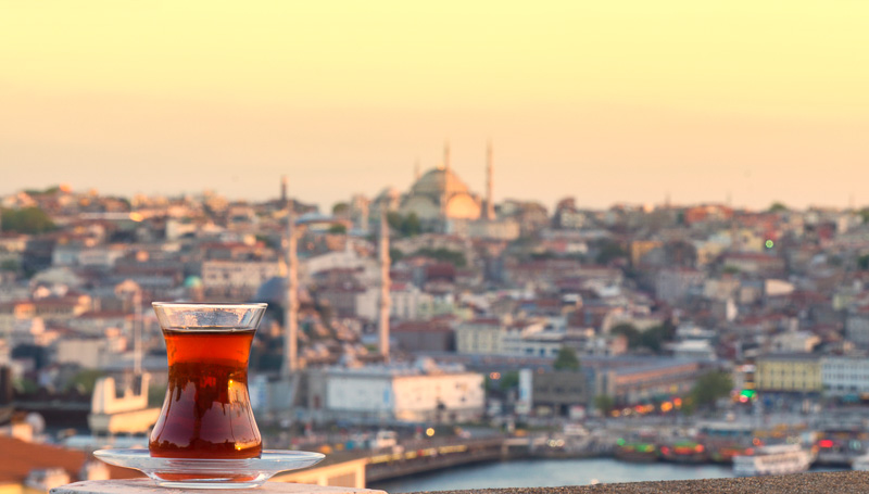 glass of Turkish tea against the background of the center of Istanbul and Bosporus, Turkey