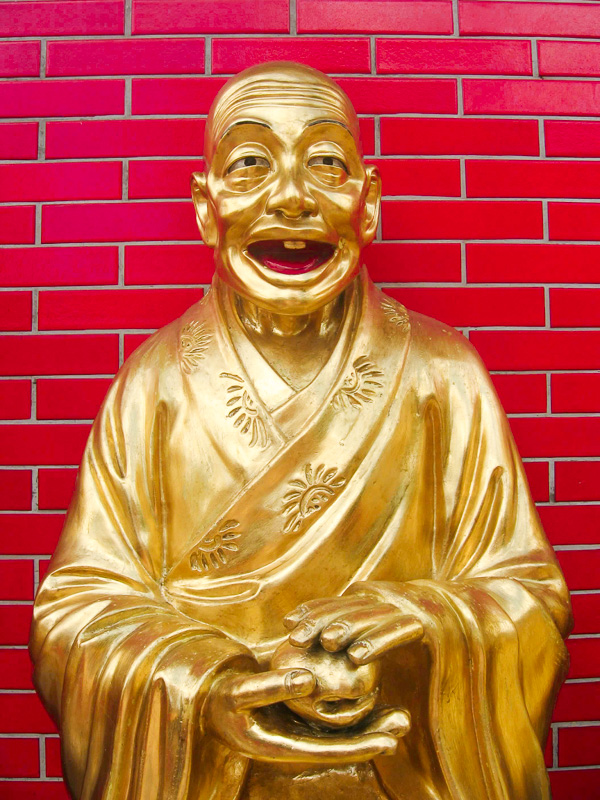 gold statue of laughing buddha