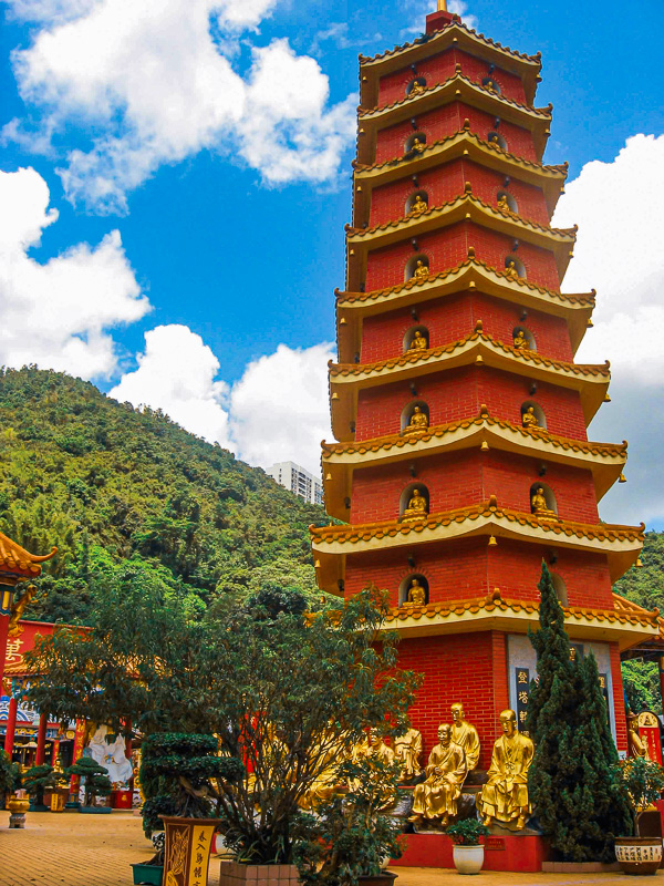 tall red pagoda surrounded by mountains
