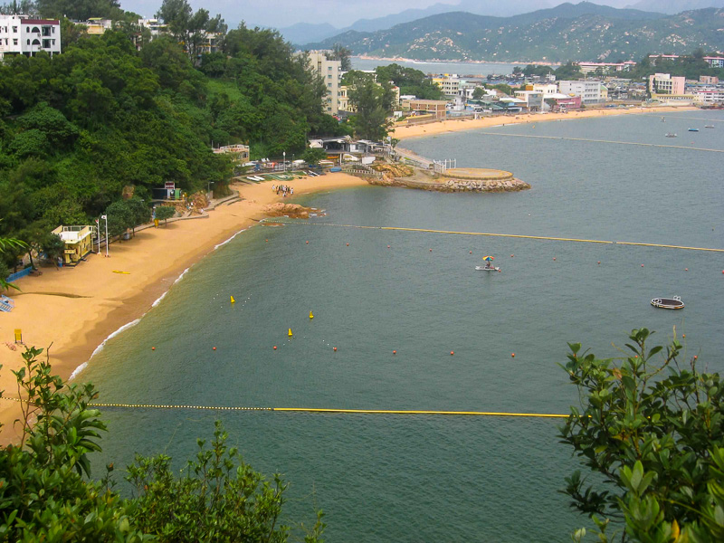 golden beaches with buildings and forested hills of Cheung Chau 