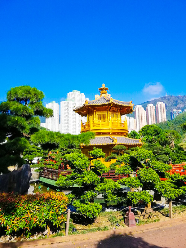 yellow temple surrounded by gardens