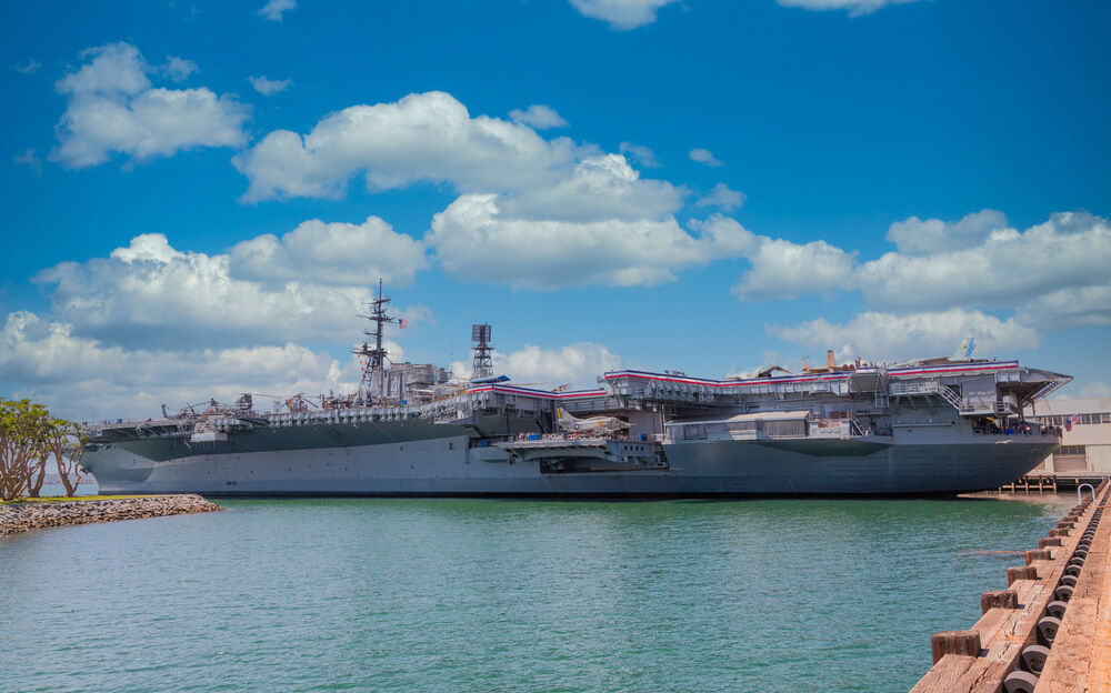 navy ship docked at bay