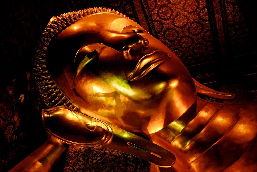 large buddha head lying on hand