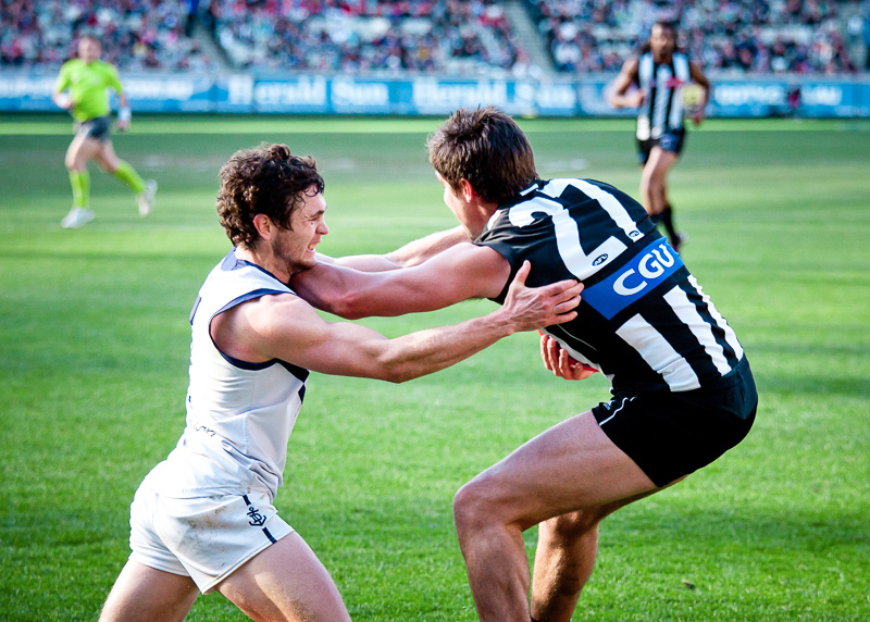 Simon Buckley (R) evades a tackle during Collingwood's win over Fremantle on June 30, 2012 in Melbourne, Australia.