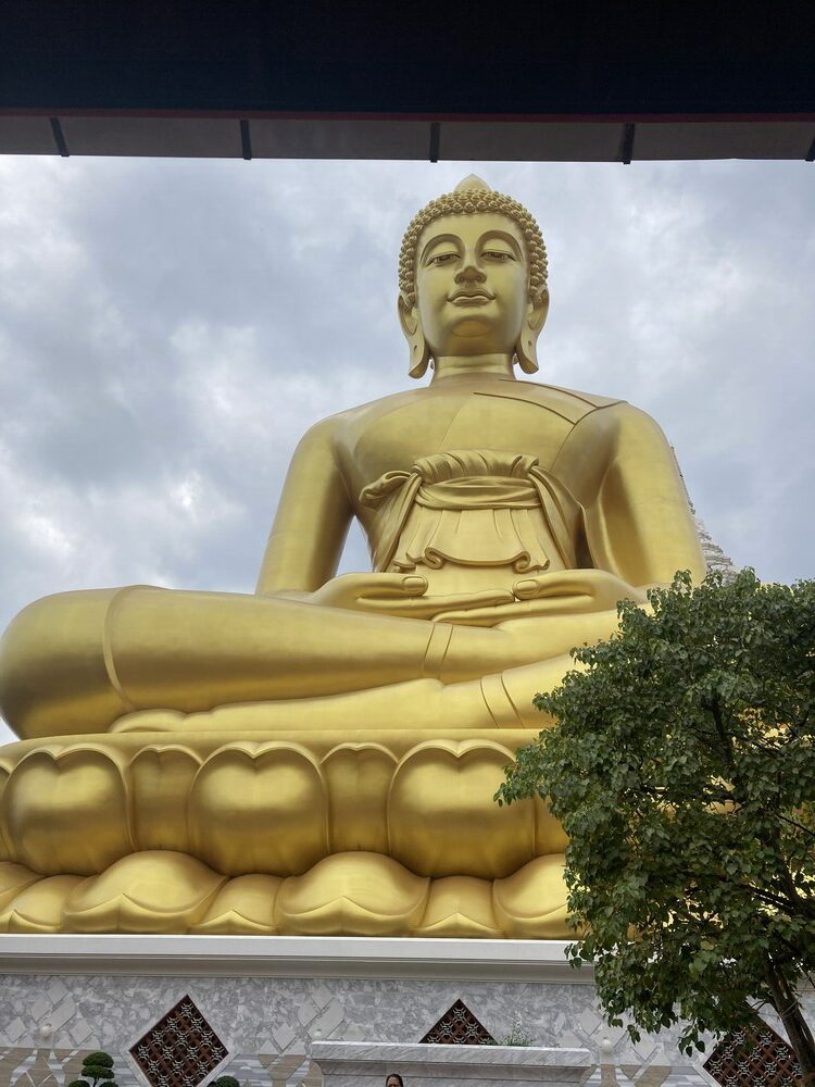 giant golden buddha statue sitting cross legged