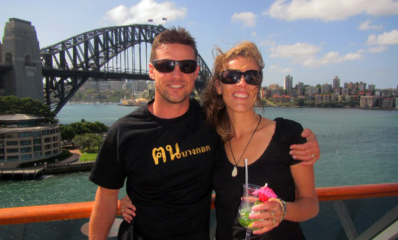 couple posing for camera with sydney opera houes behind them