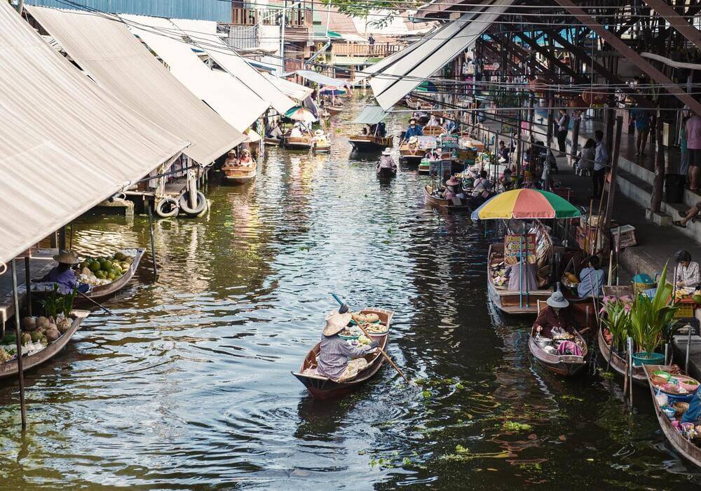 boats on canal at damnoen saduak floating market