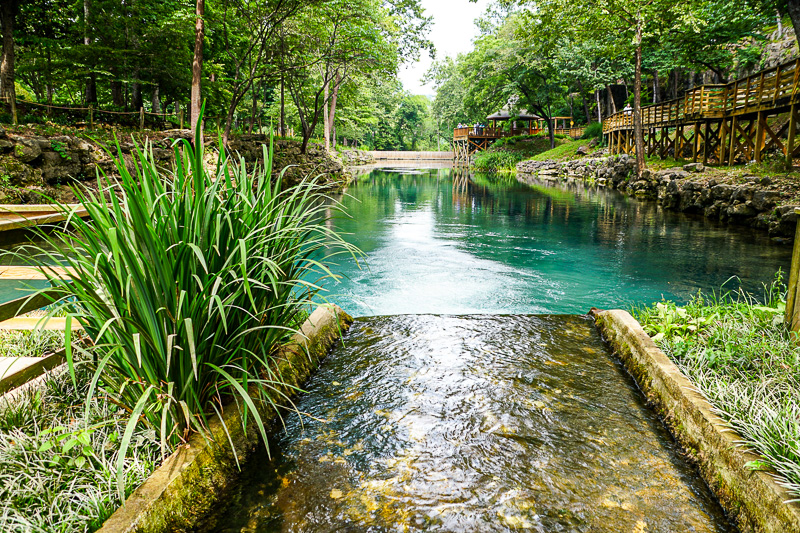 Beautiful landscape and blue water of a natural spring near Blue Spring Heritage Center, Eureka Springs, Arkansas, U.S.A