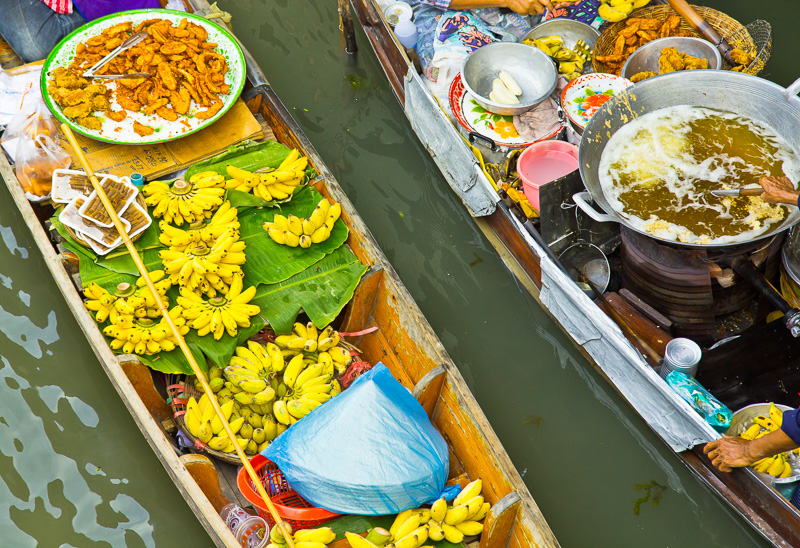 fruit and street food on long tailed boats at market