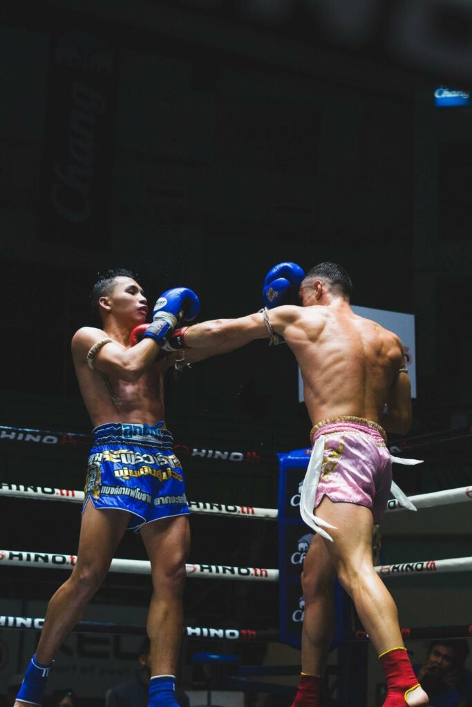 two thai men fighting Muay Thai in a ring