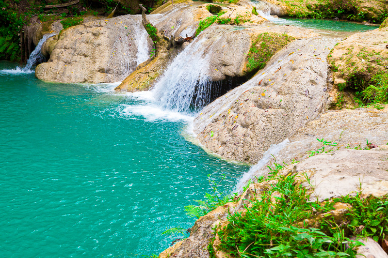 aqua waters of the blue hole with water spilling over rocks