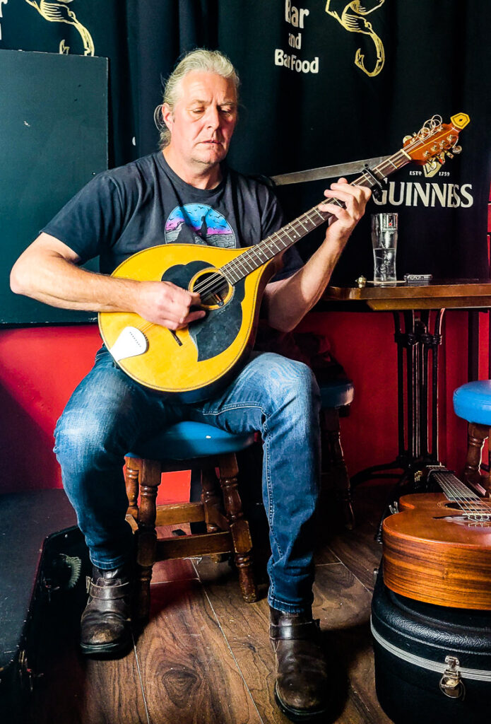 Irish musician playing a guitar