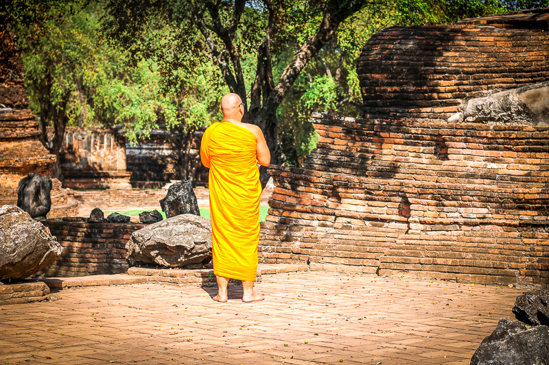 thai buddhist monk walking around Ayutthaya historic park