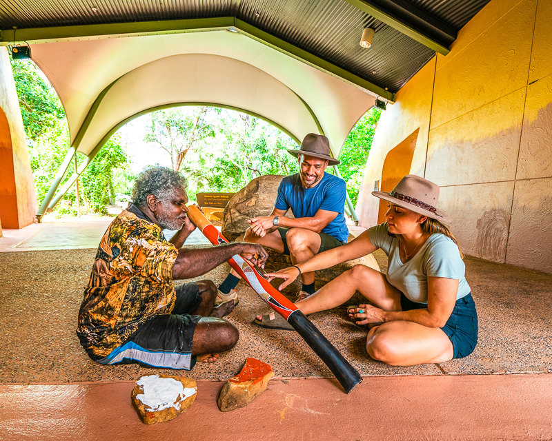 couple with artist painting didgeridoos at the Warradjan Aboriginal cultural centre