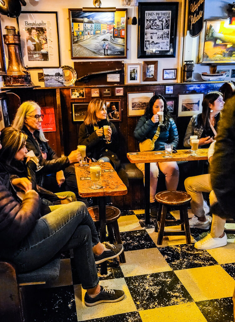 People sitting around a pub drinking