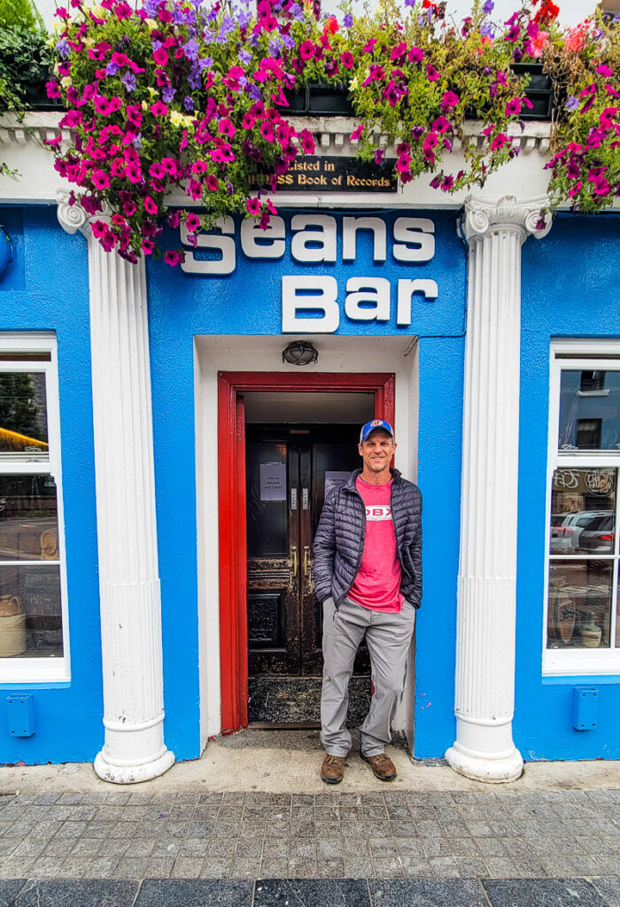 Man standing in the door entrance to a pub