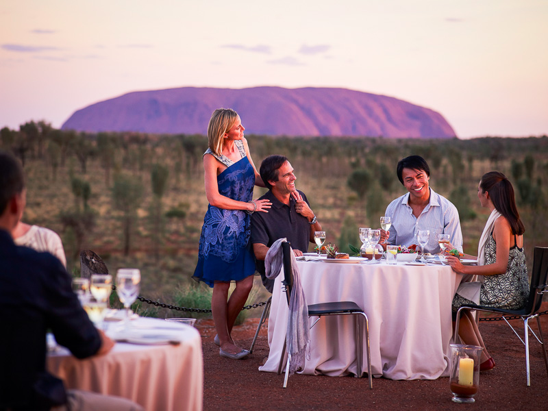 people sitting at tables near uluru for sound of silence dinner