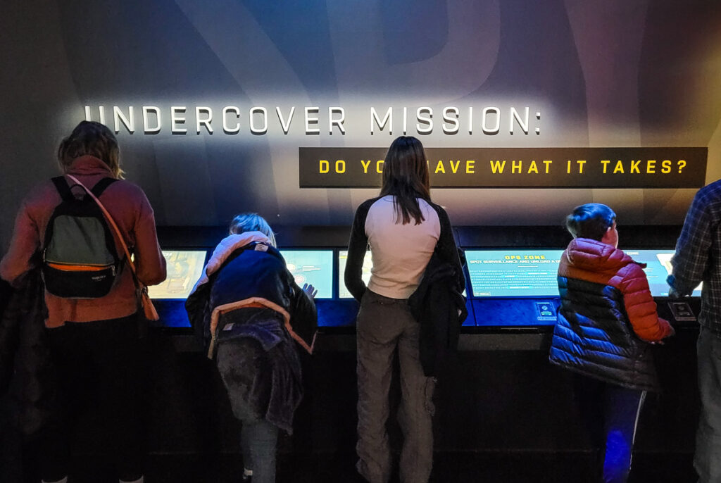 People exploring a spy museum in DC