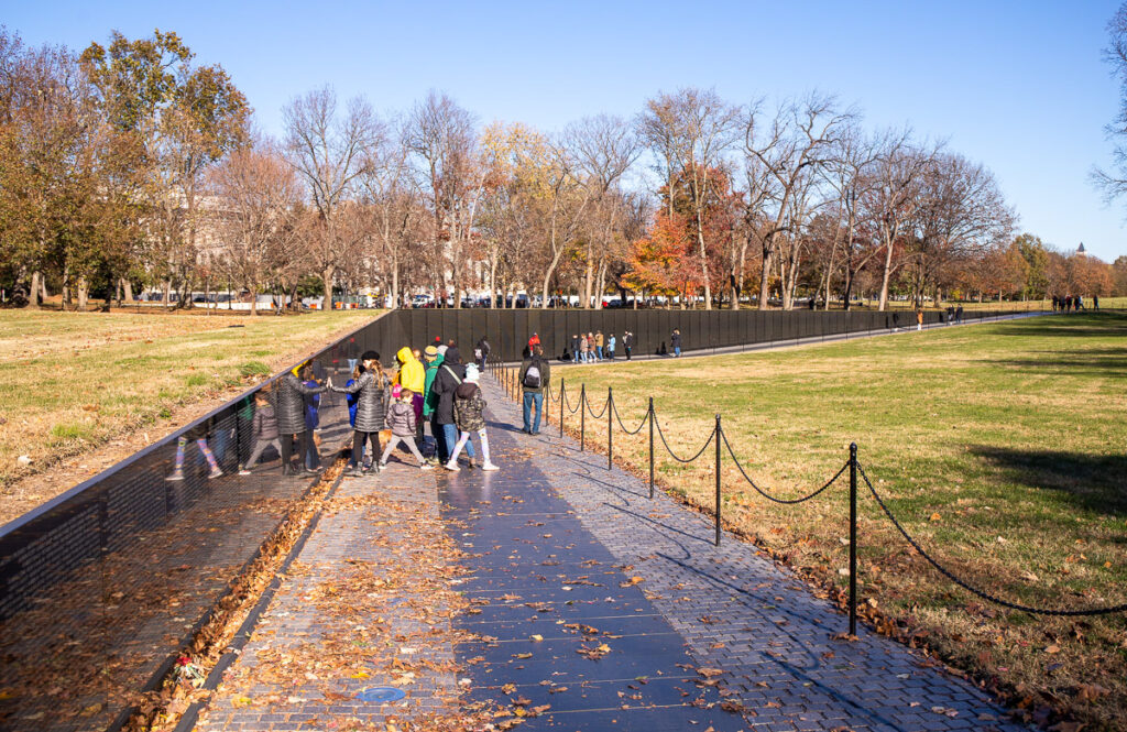 People looking at a war memorial in Washington DC