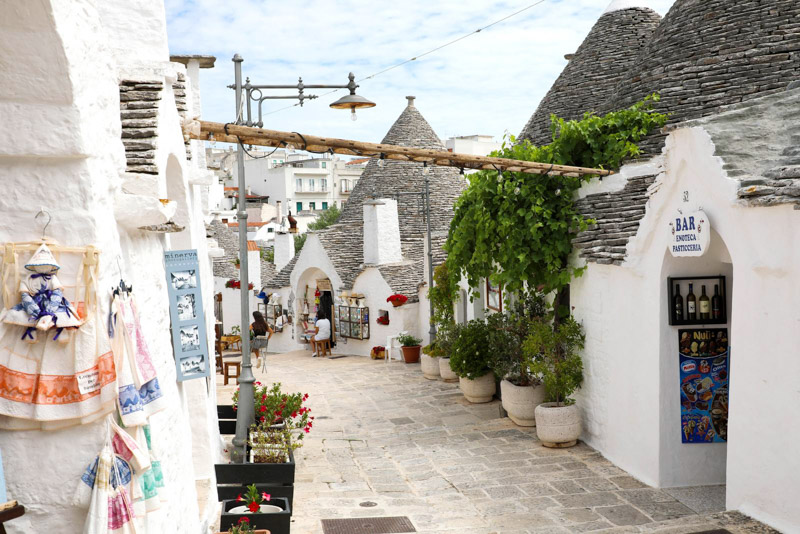 the colony   of Alberobello with souvenir shops successful  Trulli houses, Puglia, Italy