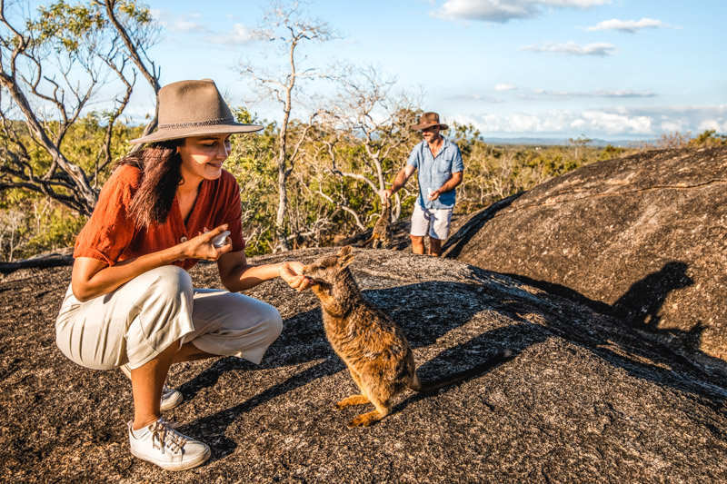 Couple with rock wallabies in granite gorge nature park