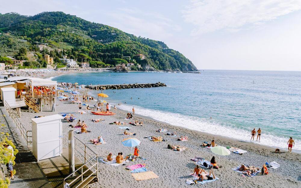 people lying on sand at Levanto
