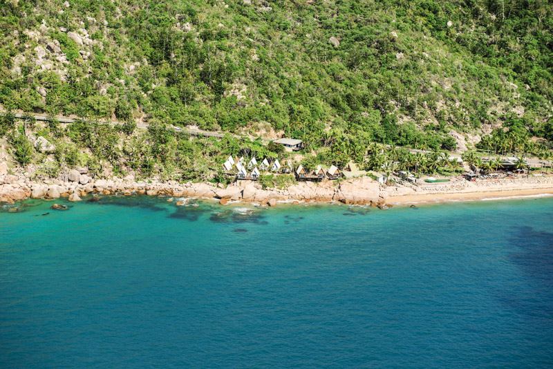 aerial view of coastline with cottages on the edge