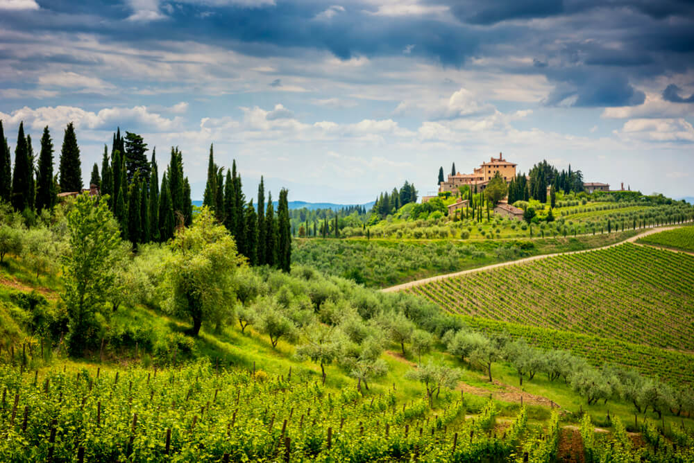 hilly mountains with villa on top in tuscany