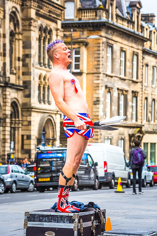 Street performer Spikey Will standing on a case at the Edinburgh Fringe Festival. 