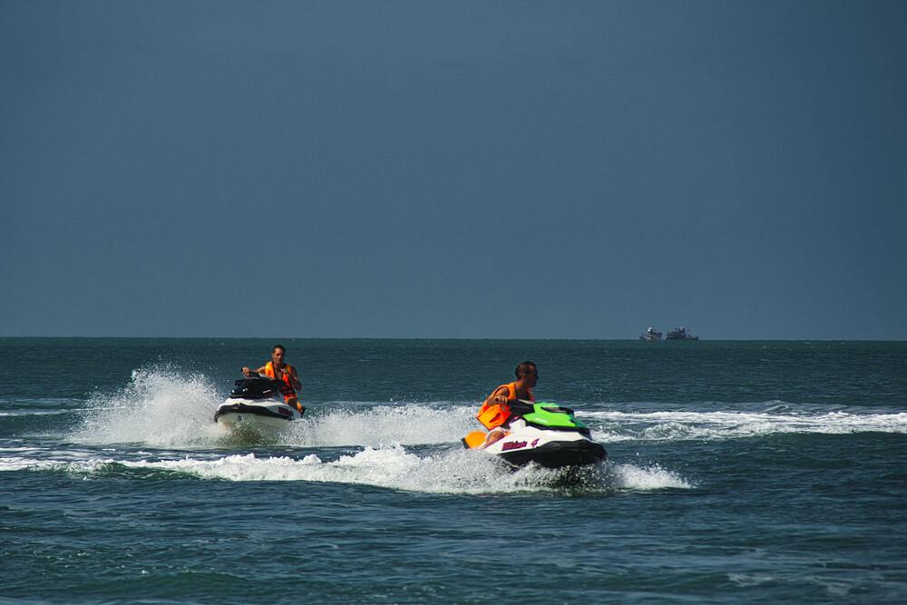 two people riding jet skis