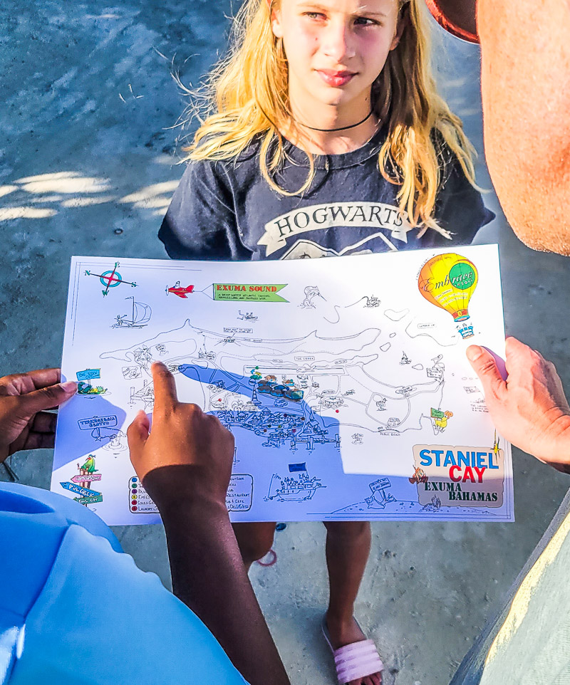 Young girl looking at a map of an island